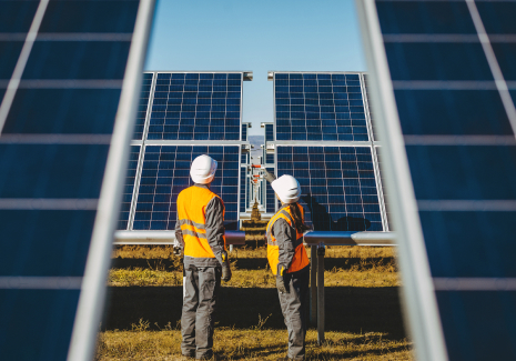 Workers inspecting solar panels.